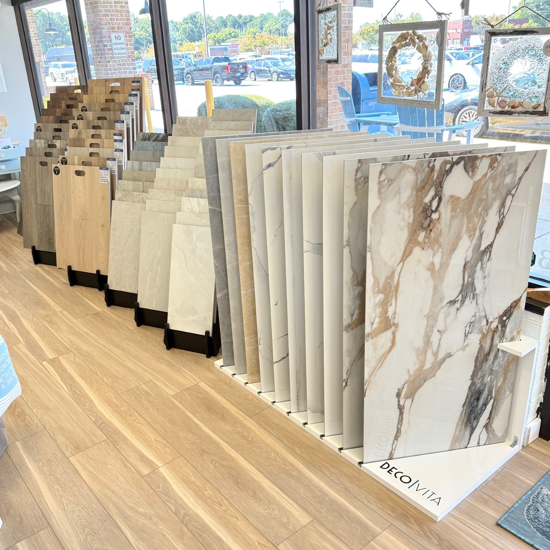 Tile samples displayed in a store. Various colors, patterns, and textures are shown.
