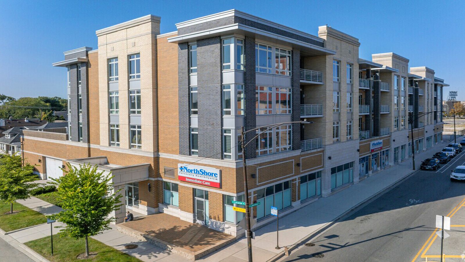 Modern apartment building with brick, aluminum composite panel, and glass facade.