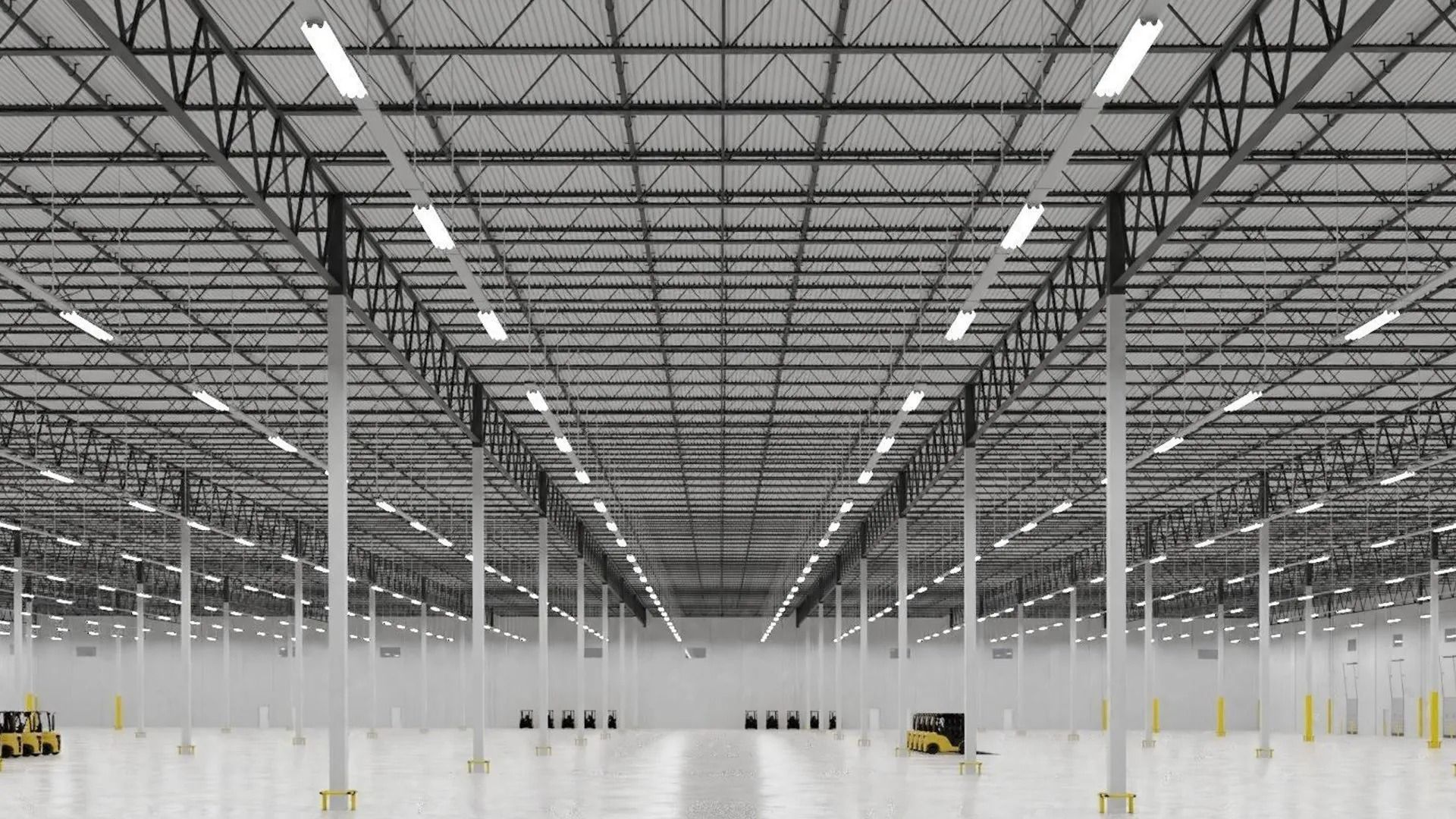 Empty warehouse interior with rows of white columns, overhead lights, and polished concrete floor