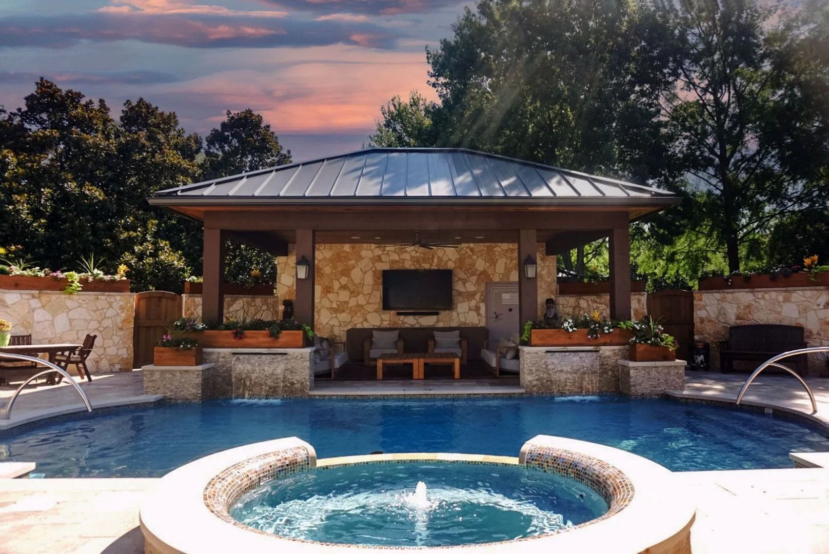 Backyard pool with a round spa and a covered pavilion