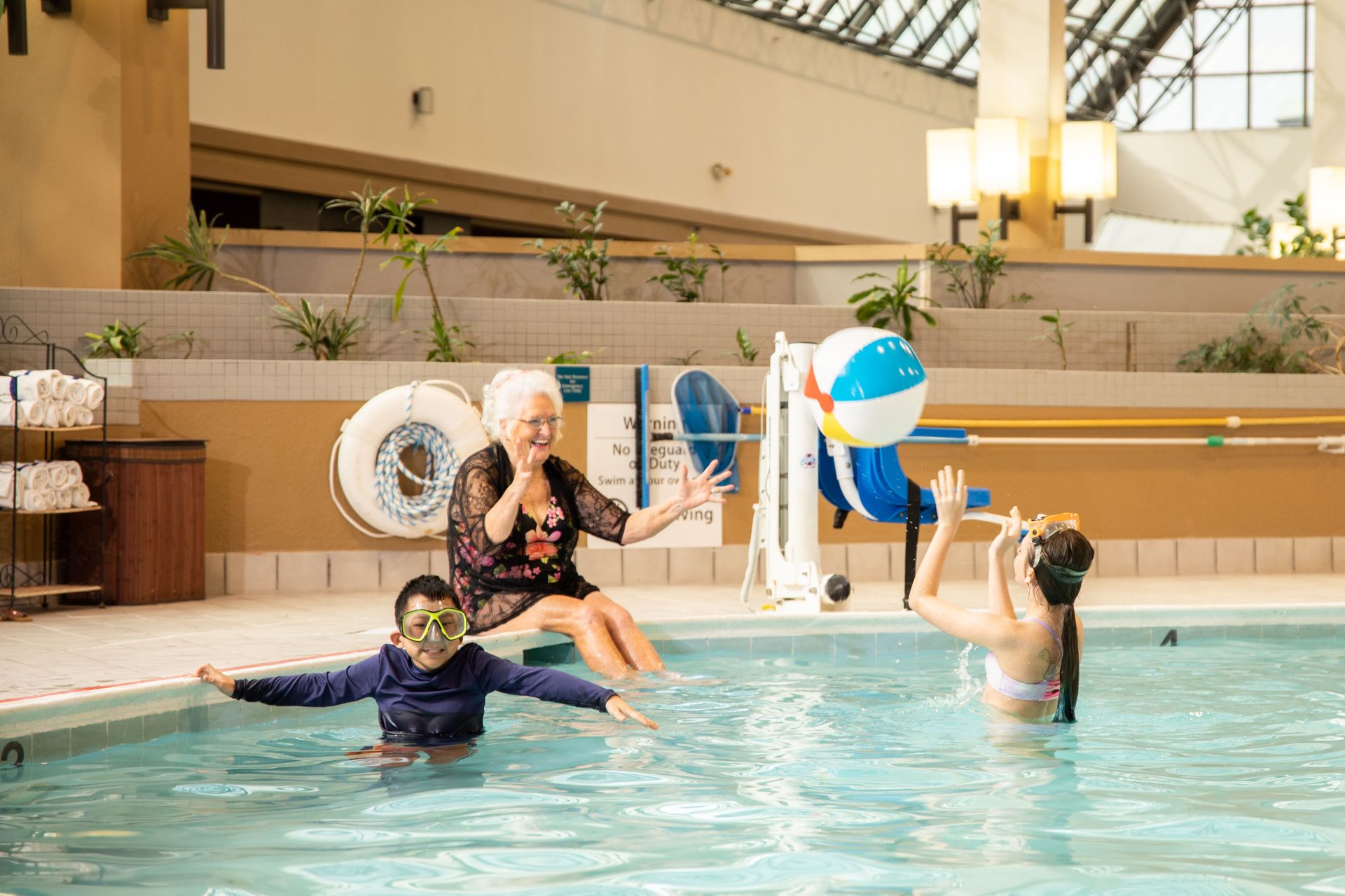 A group of people are playing in a swimming pool.
