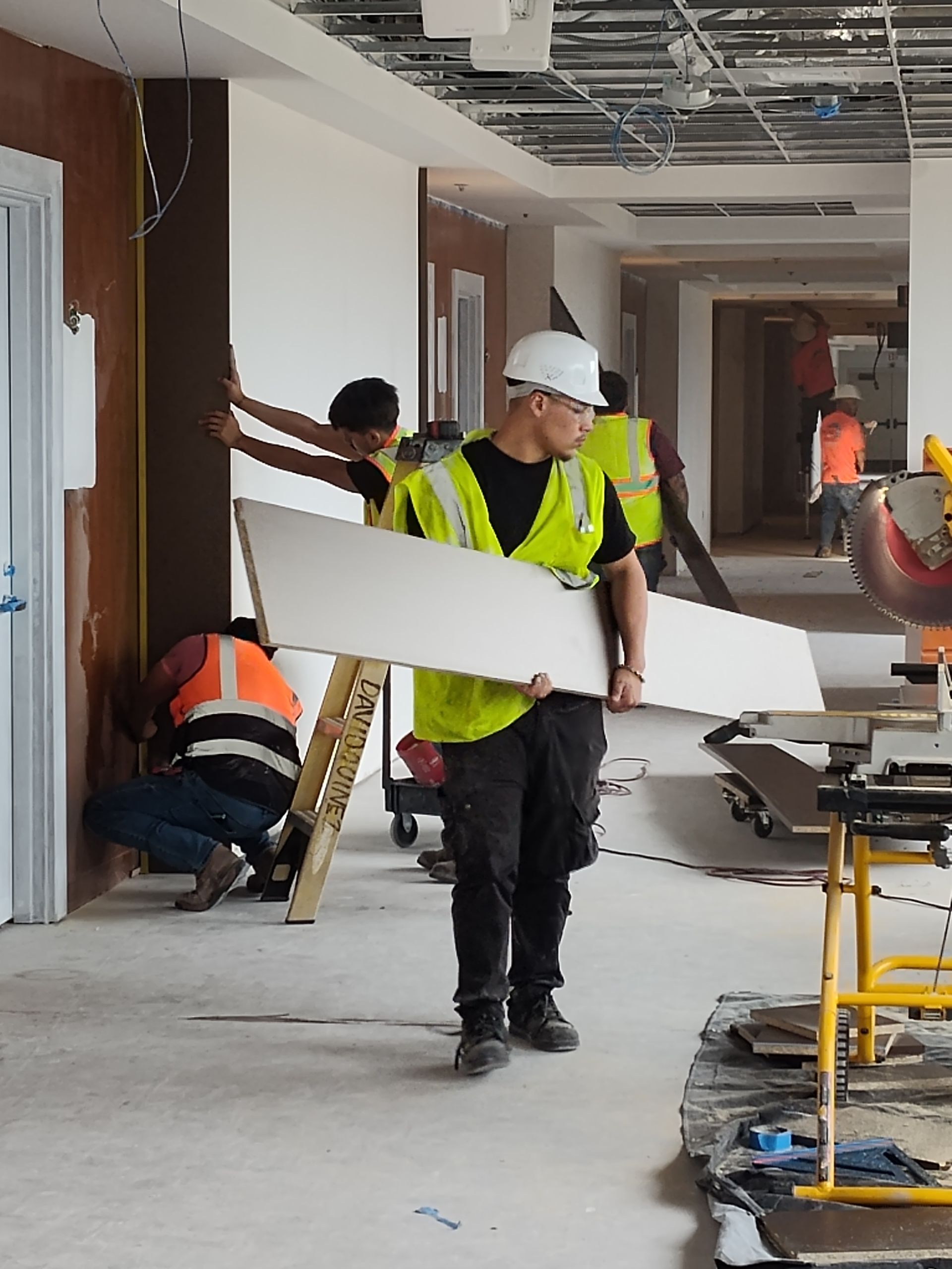 A group of construction workers are working on a building.