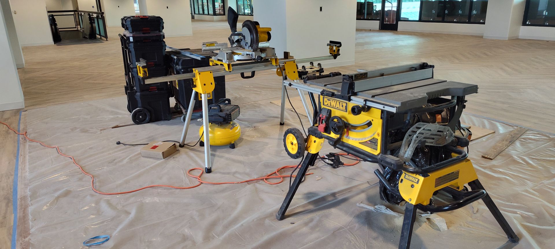A table saw and a circular saw are sitting on a table in a room.