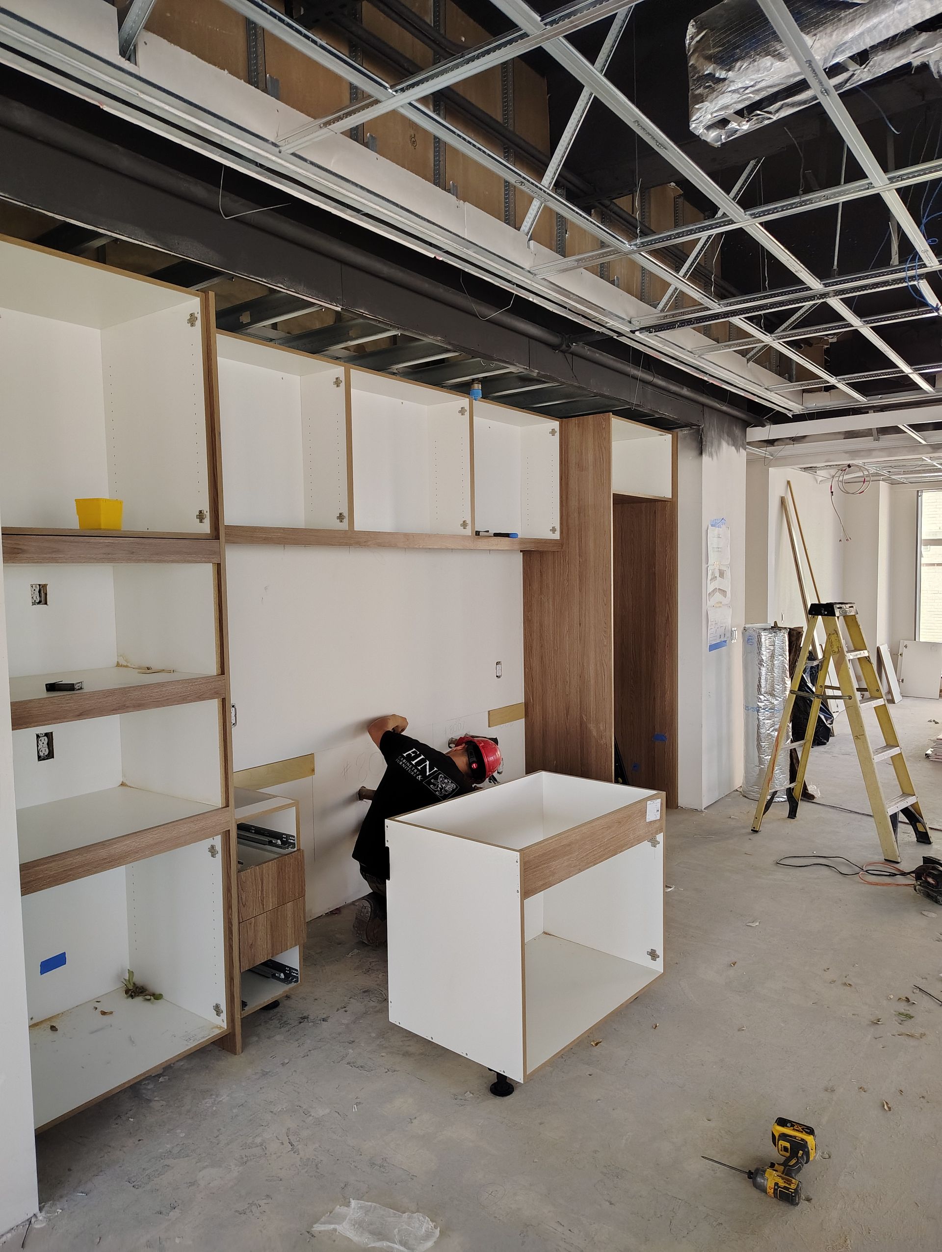 A room with a lot of shelves and a ladder.