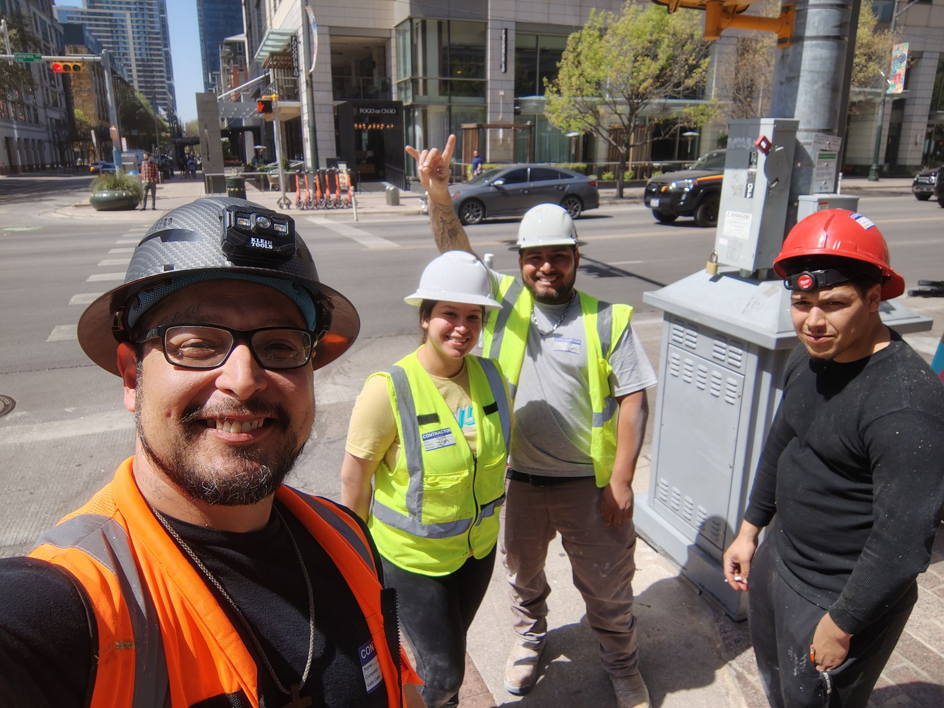 A group of construction workers are posing for a picture.