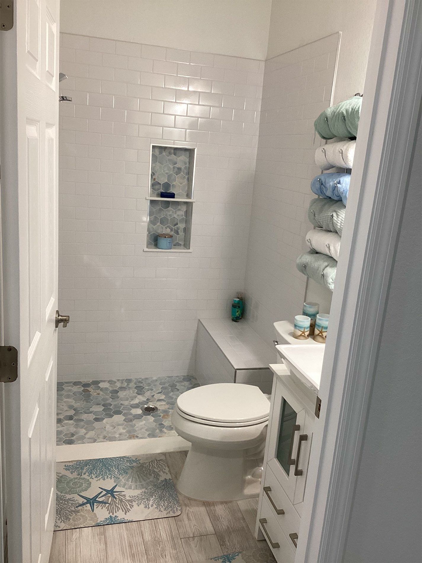 A bathroom with a toilet , sink , and shower.