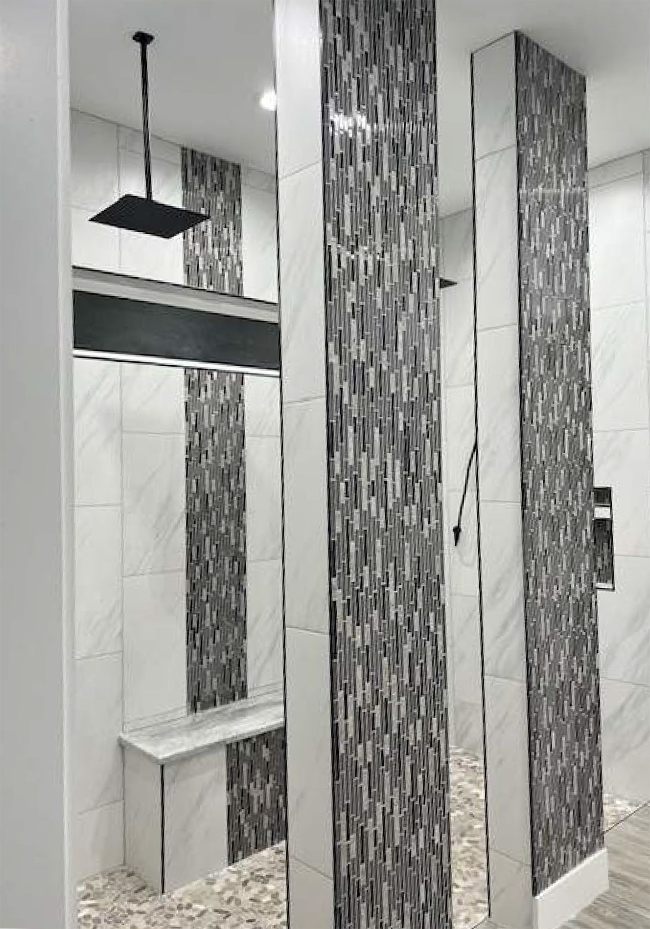 A bathroom with a walk in shower and a bench.