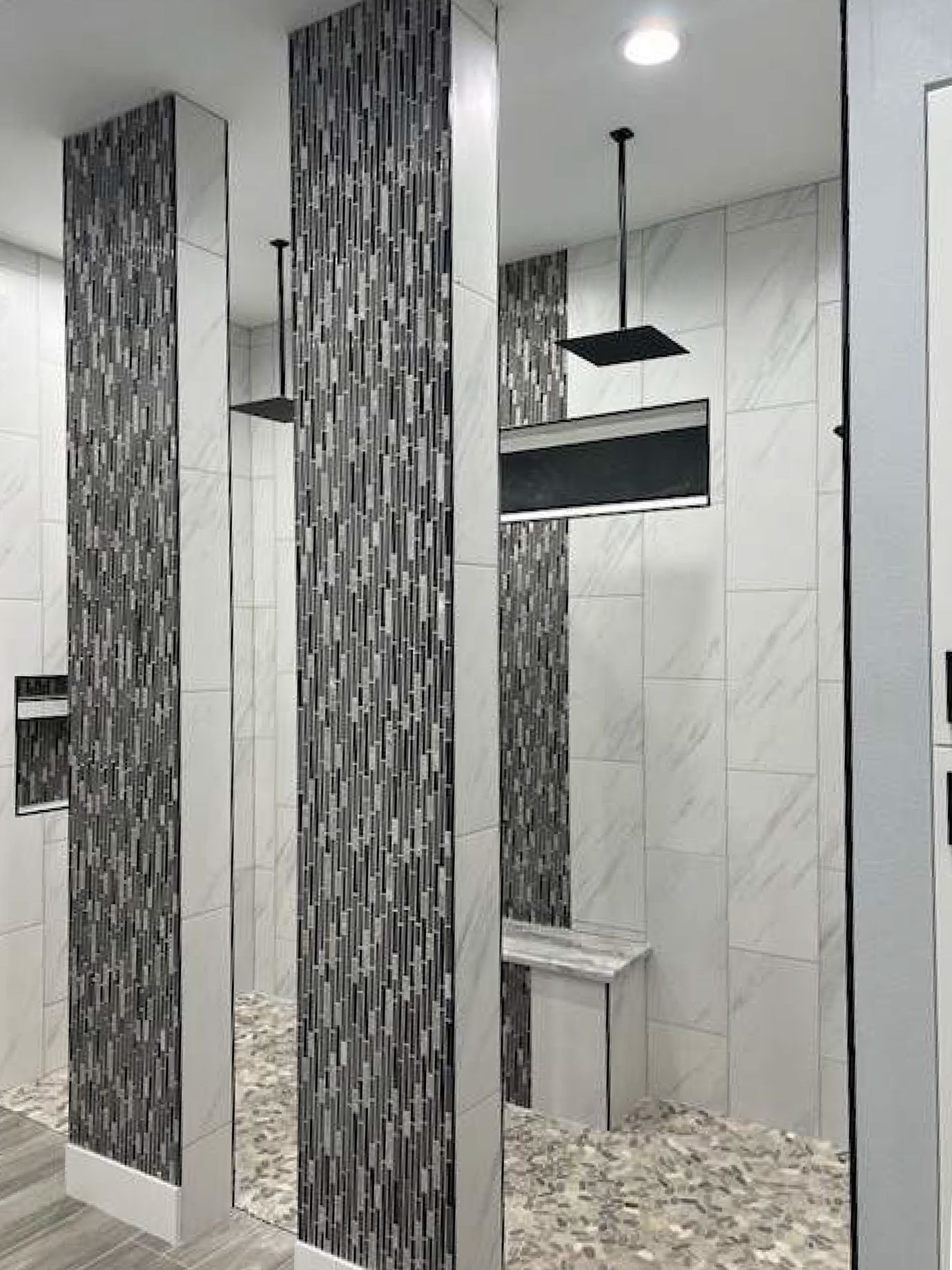 A bathroom with a walk in shower and a sink.