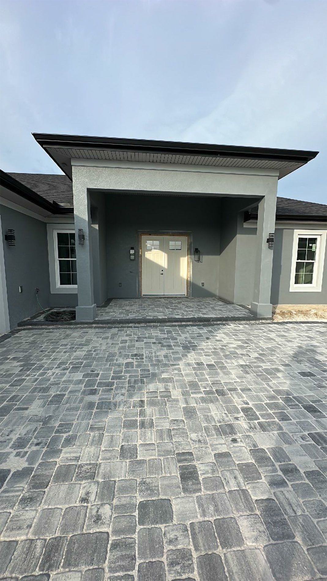 The front of a house with a driveway and a porch.