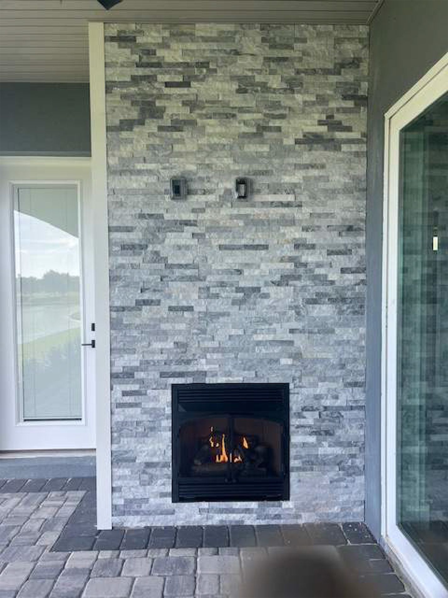 There is a fireplace in the middle of the wall.