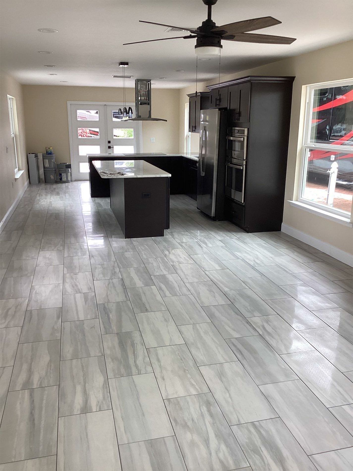 A kitchen with a ceiling fan and a large island.