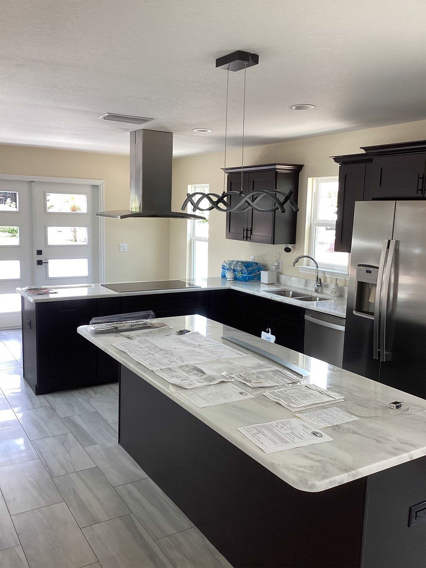A kitchen with a large island and stainless steel appliances.