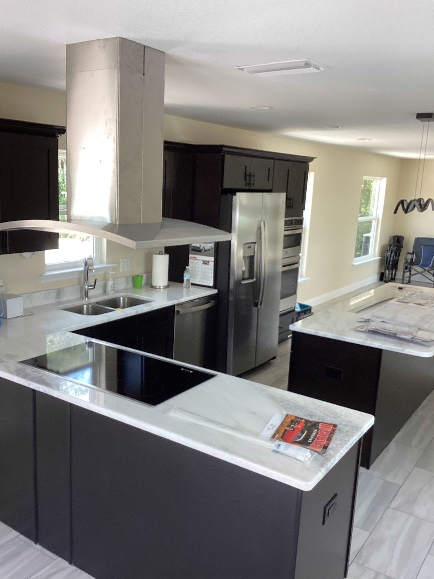 A kitchen with stainless steel appliances and black cabinets