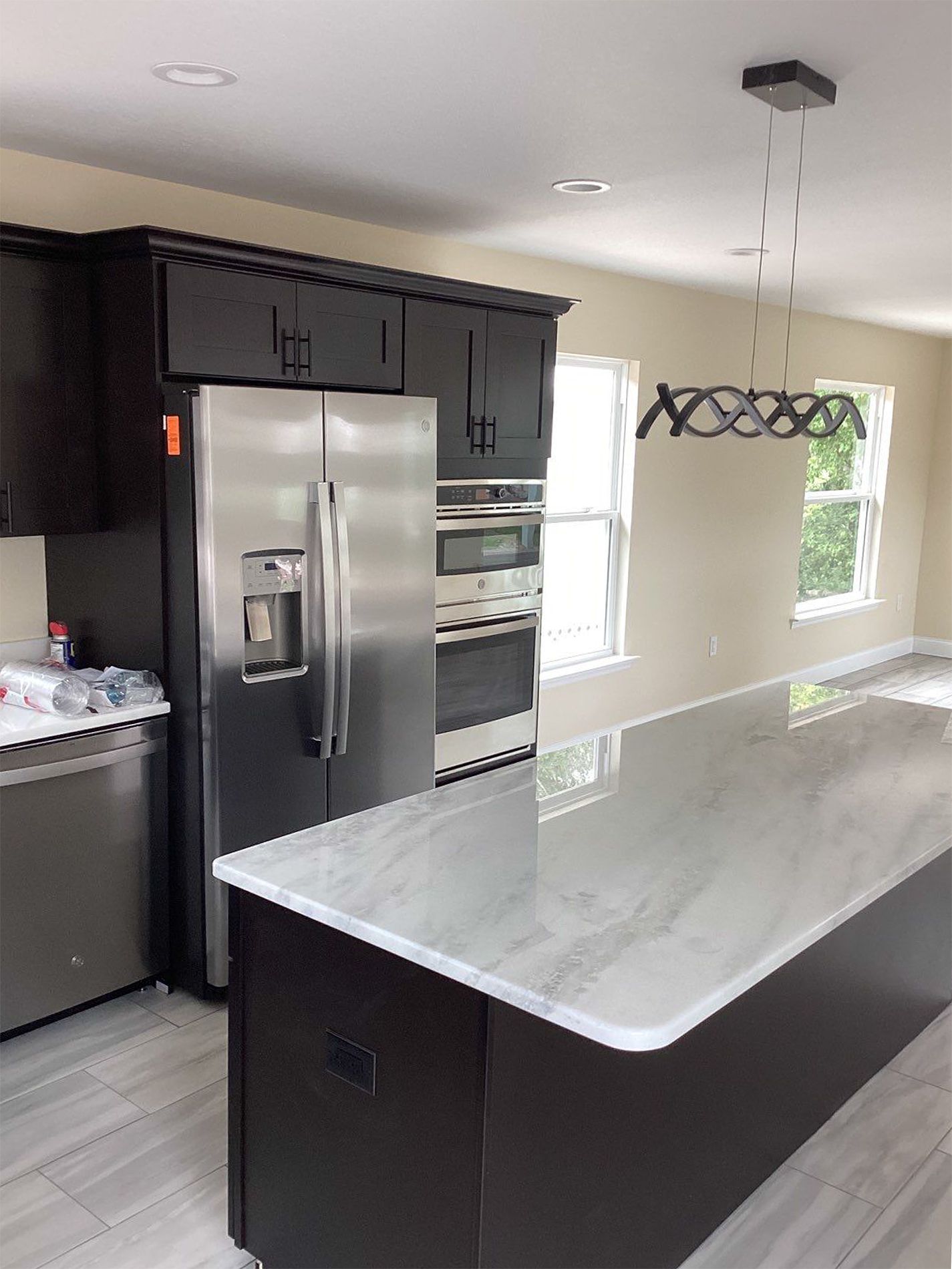 A kitchen with stainless steel appliances and a large island.