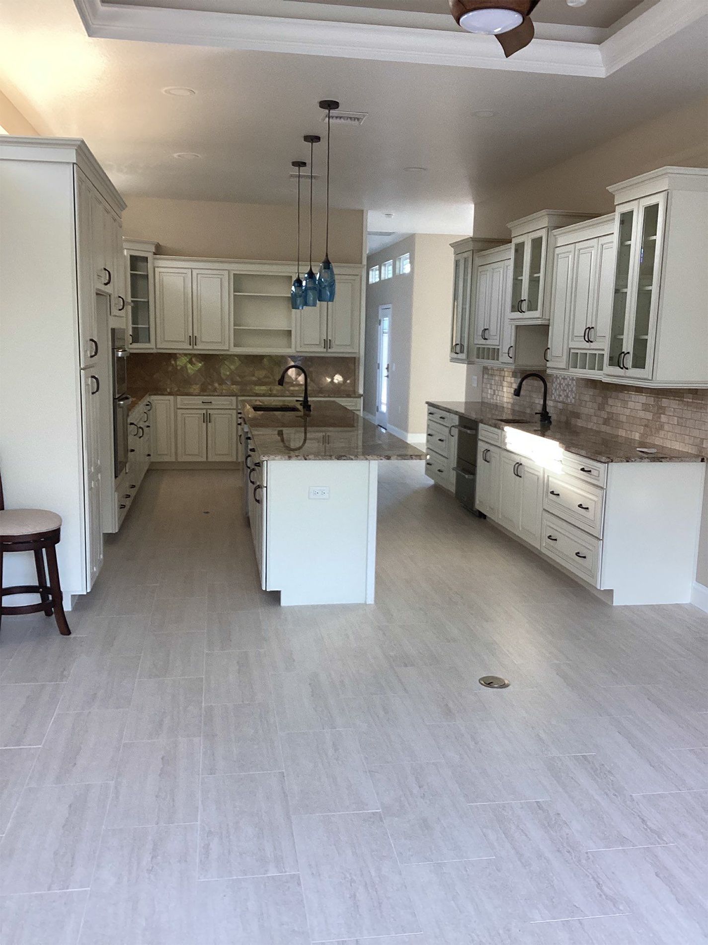 A kitchen with white cabinets and granite counter tops