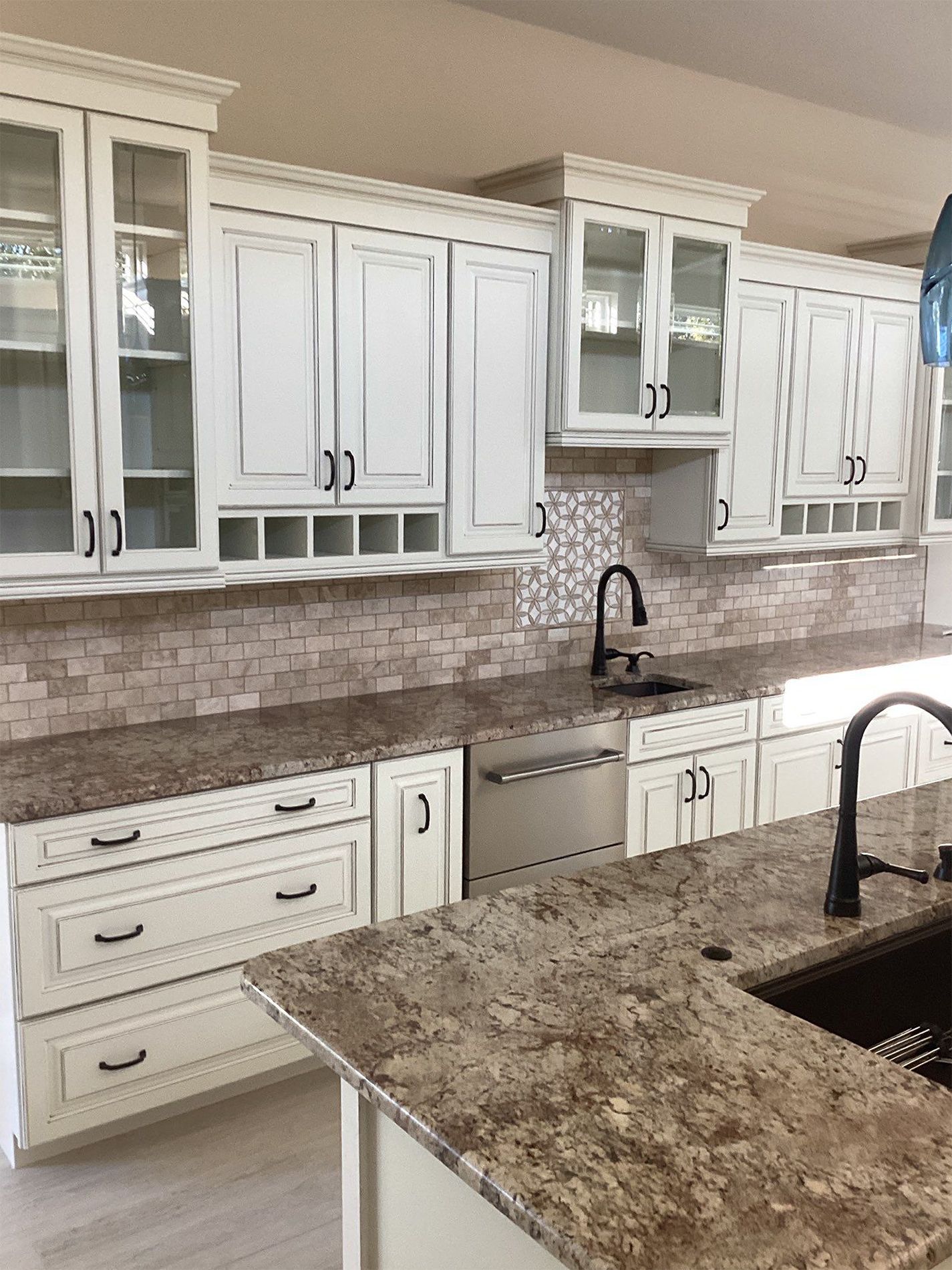 A kitchen with white cabinets and granite counter tops