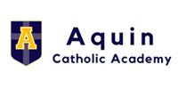 Logo for Aquin Catholic Academy, featuring a shield with a yellow 