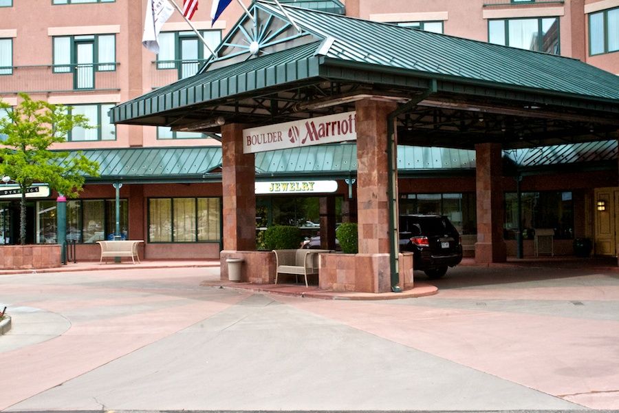 A car is parked in front of a Marriott hotel.