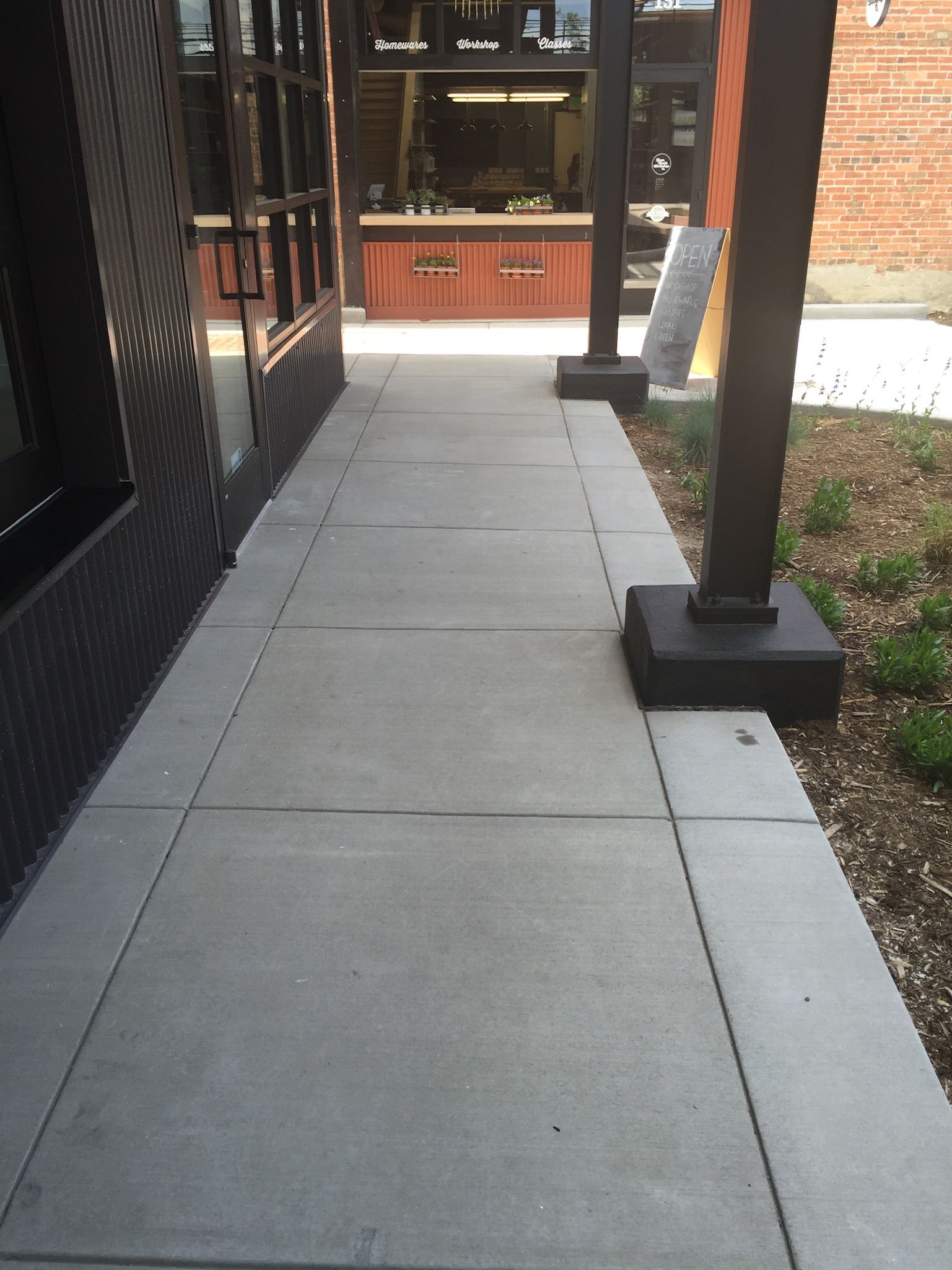 A brick walkway with a bench in the middle.