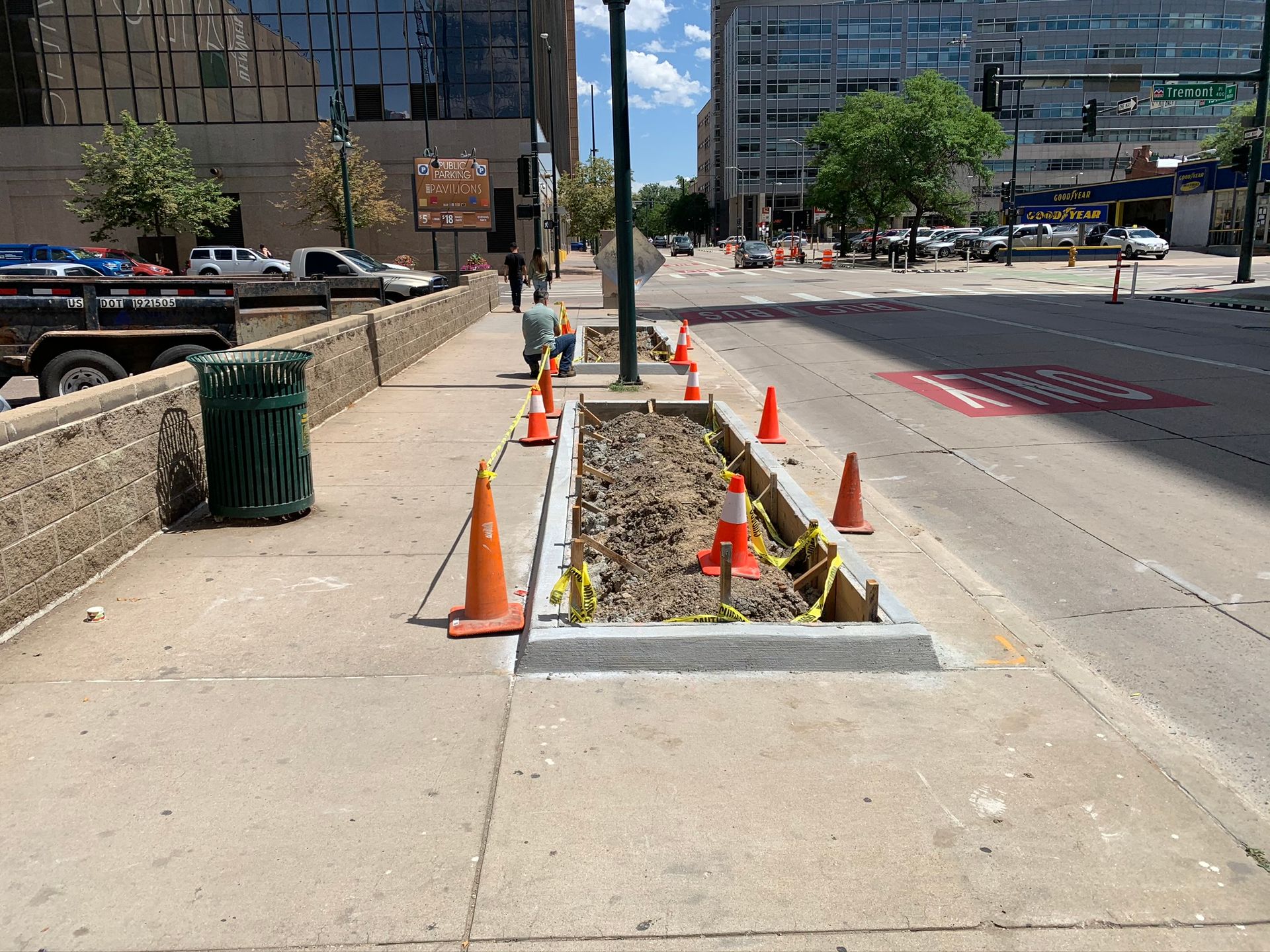 A man stands in front of a whole foods store.