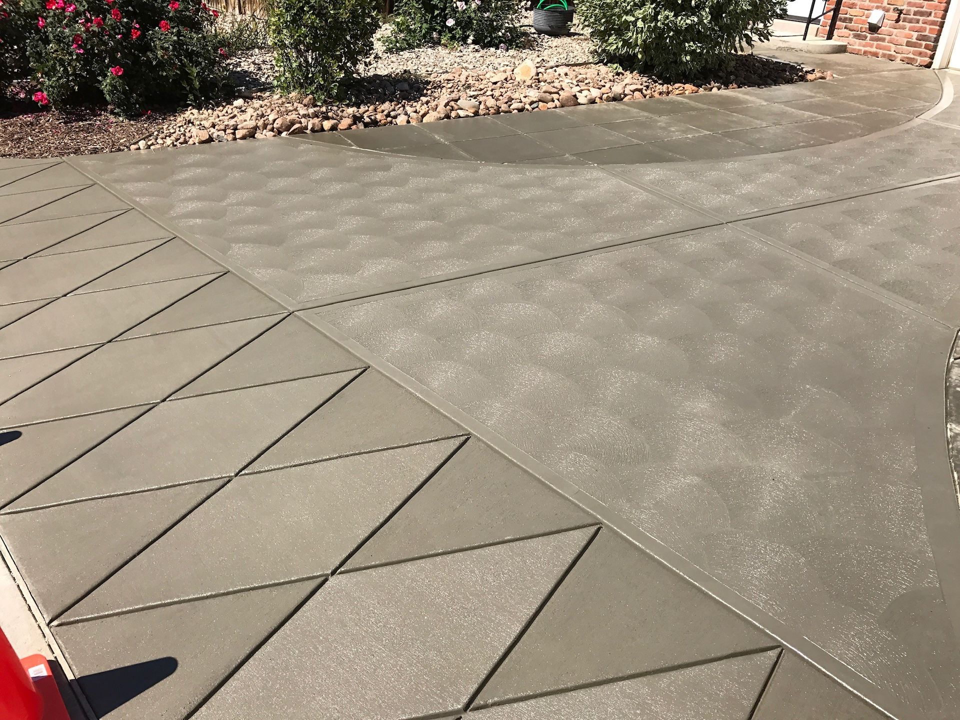 A concrete driveway with a diagonal pattern on it