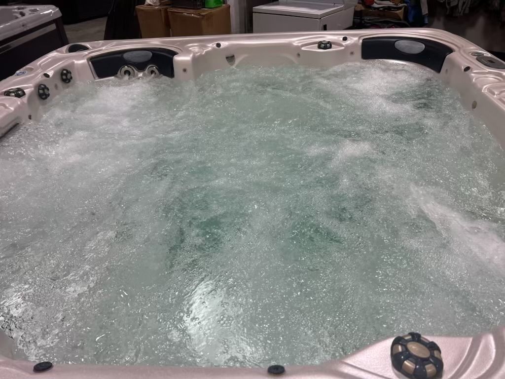 Hot tub filled with bubbly water, jets on, ready for use.