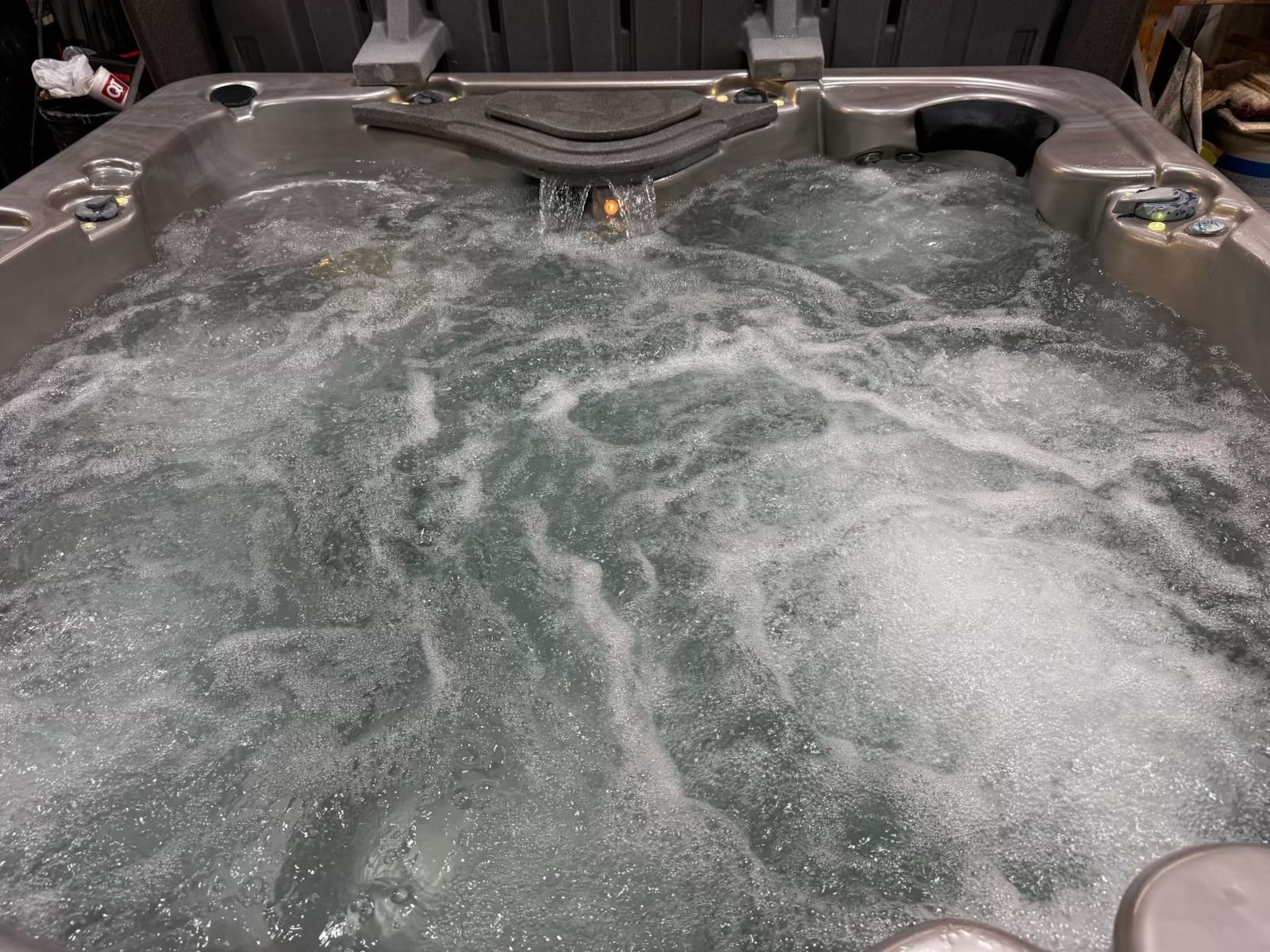 Bubbling hot tub with water jets, overflowing into a spa.