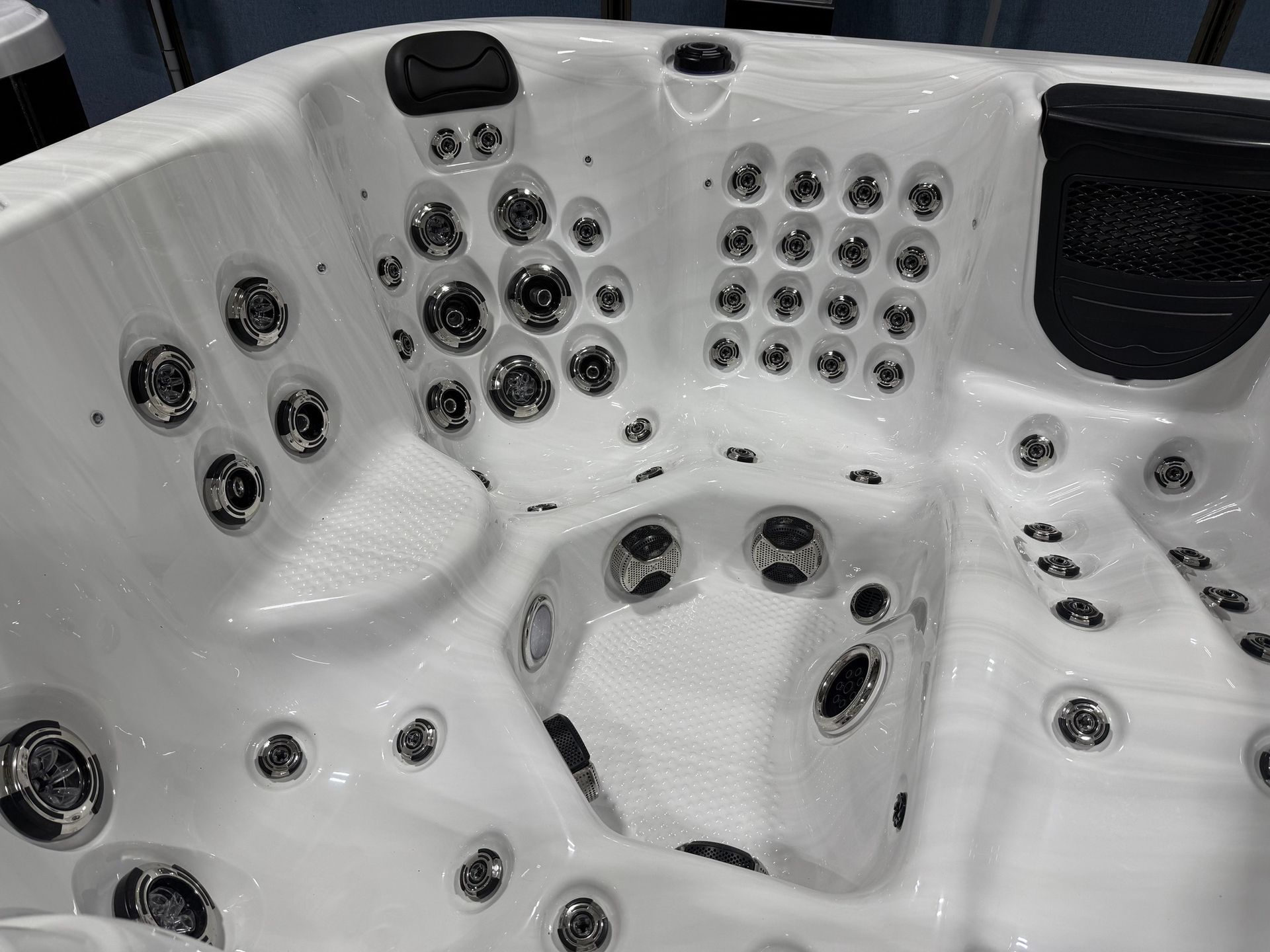White hot tub with multiple jets and seating areas.